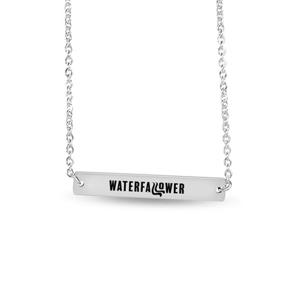 Silver necklace with a bar pendant engraved 'WATERFALLFLOWER' on a white background